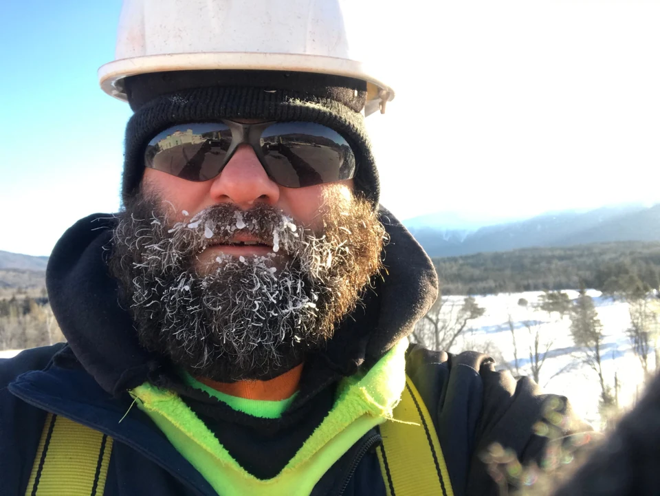 Kyle West in hard hat and field gear on Mount Washington